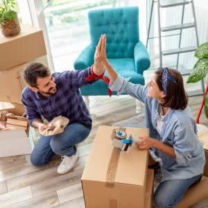 a couple packing up their home before it's cleaned by Abby's Cleaning Service's move-in/move-out cleaning service