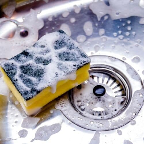 A sponge and a soapy sink during a deep cleaning by Abby's Cleaning Service